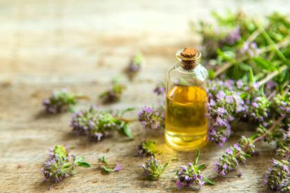 Essential oil of thyme in a bottle. Selective focus.