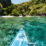 Trip tourist boat in blue shallow water lagoon. Discover exploring unique nature, journey to