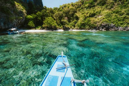 Trip tourist boat in blue shallow water lagoon. Discover exploring unique nature, journey to